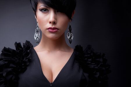 Young beautiful stylish girl posing in studio.の写真素材