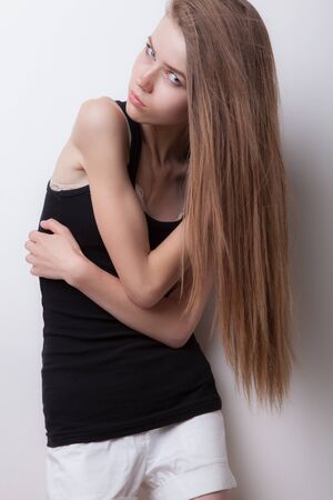 Young beautiful stylish girl posing in studio.の写真素材