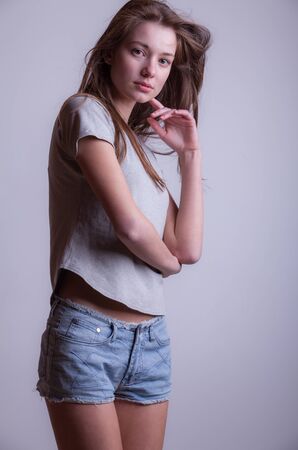Young beautiful stylish girl posing in studio.の写真素材