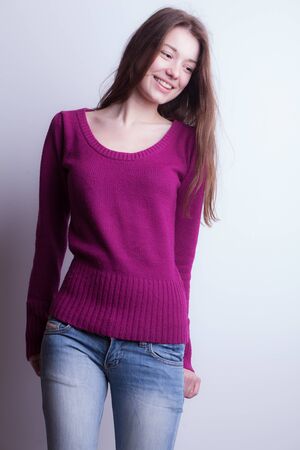 Young beautiful stylish girl posing in studio.の写真素材
