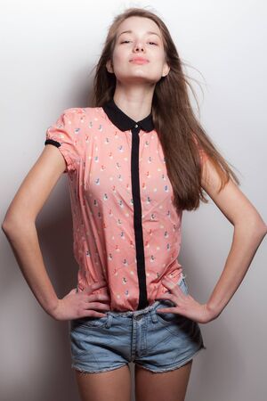 Young beautiful stylish girl posing in studio.の写真素材