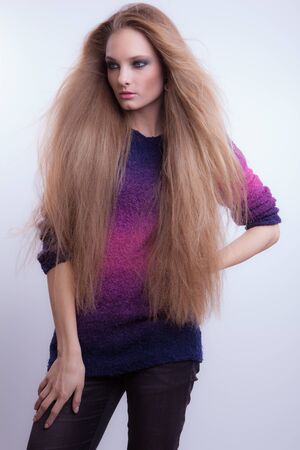 Young beautiful stylish girl posing in studio.の写真素材