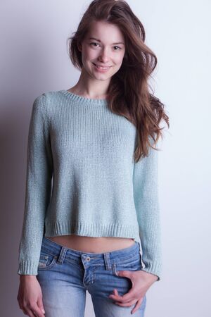 Young beautiful stylish girl posing in studio.の写真素材