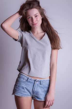 Young beautiful stylish girl posing in studio.の写真素材