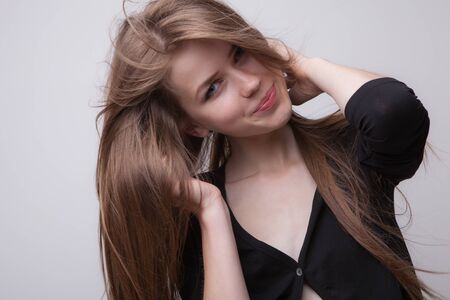 Young beautiful stylish girl posing in studio.の写真素材