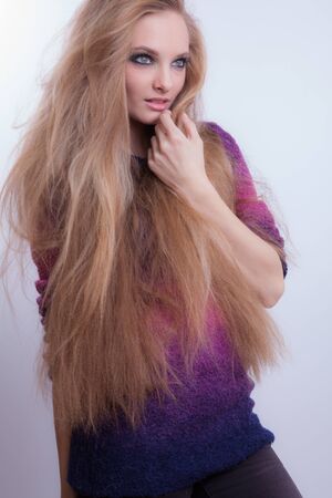 Young beautiful stylish girl posing in studio.の写真素材