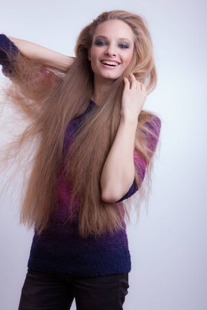 Young beautiful stylish girl posing in studio.の写真素材