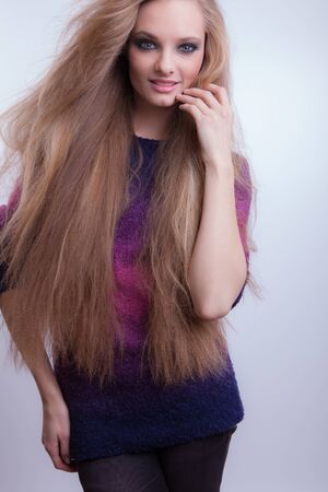 Young beautiful stylish girl posing in studio.の写真素材