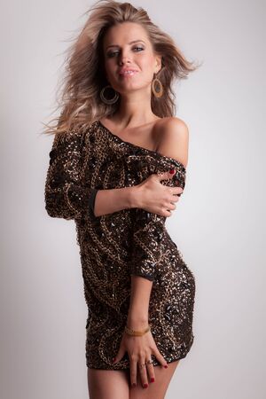 Young beautiful stylish girl posing in studio.の写真素材
