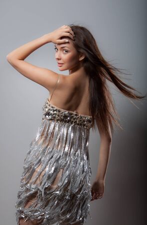 Young beautiful stylish girl posing in studio.の写真素材