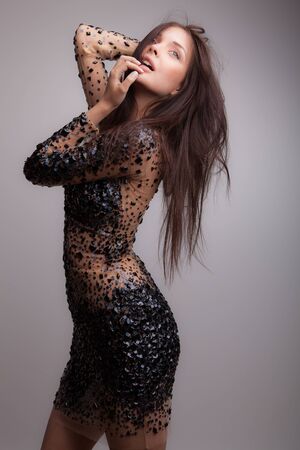 Young beautiful stylish girl posing in studio.の写真素材