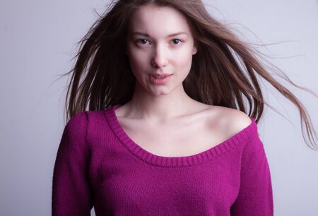 Young beautiful stylish girl posing in studio.の写真素材