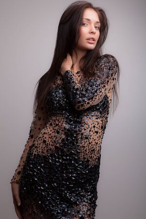 Young beautiful stylish girl posing in studio.の写真素材