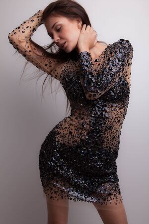 Young beautiful stylish girl posing in studio.の写真素材