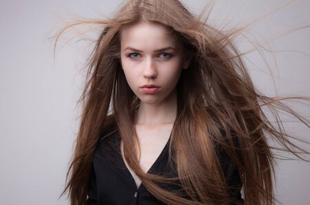 Young beautiful stylish girl posing in studio.の写真素材