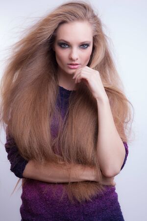 Young beautiful stylish girl posing in studio.の写真素材