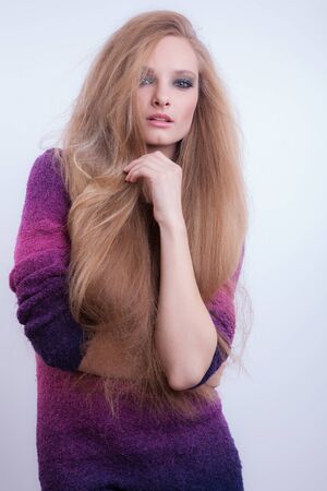 Young beautiful stylish girl posing in studio.の写真素材