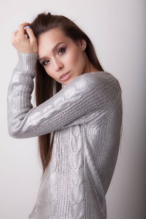 Young beautiful stylish girl posing in studio.の写真素材