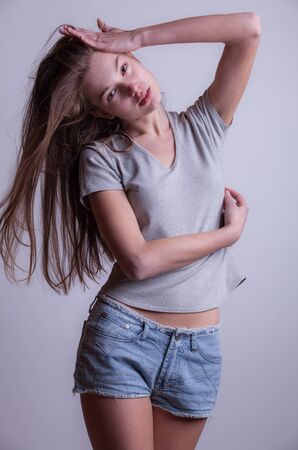 Young beautiful stylish girl posing in studio.の写真素材