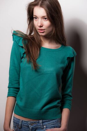 Young beautiful stylish girl posing in studio.の写真素材
