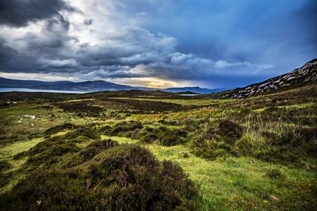 Beautiful mountains landscape of Scotland nature with beautiful evening cloudy sky.の写真素材