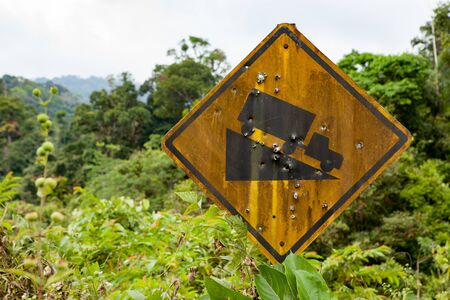 Old yellow rusted steep grade hill traffic sign.の写真素材