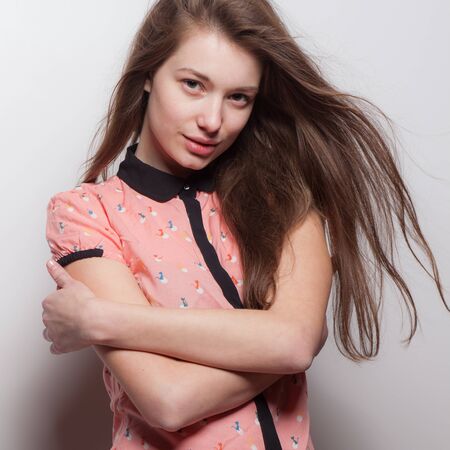 Young beautiful stylish girl posing in studio.の写真素材