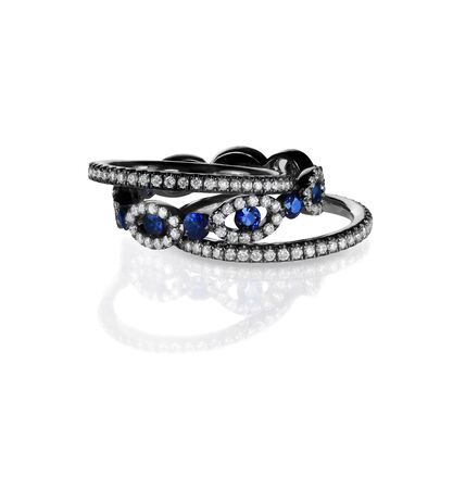 diamond and sapphire ring bands with black metal isolated on whiteの写真素材