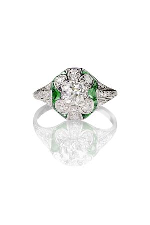 vintage mine cut engagement art deco ring with emerald stones isolated on whiteの写真素材