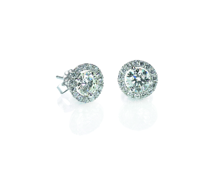 Beautiful Halo Diamond Stud earrings with reflection isolated on whiteの写真素材