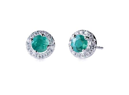 Round emerald diamond stud earrings in a halo setting isolated on white の写真素材