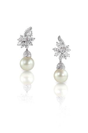 Beautiful Diamond pearl Marquise drop dangle earrings studs pair isolated on white with a reflectionの写真素材