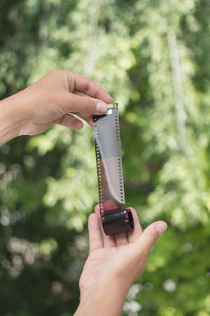 hands holding an old photo filmの写真素材