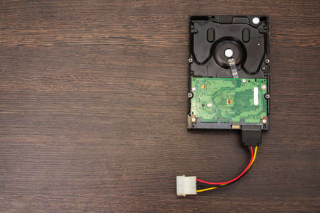 Hard disk on a wooden tableの写真素材