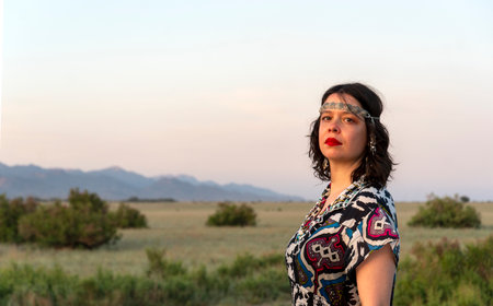 Portrait of a beautiful woman in the desert at sunset time.