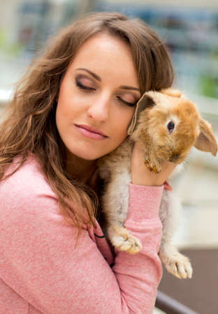 cute teen girl with gray rabbitの写真素材