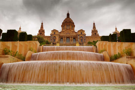 BARCELONA, circa 2015 - Wide angle shot of MNAC - Museu Nacional d'Art de Catalunya) - with a fountain against a dramatic sky in Barcelona, Catalonia, Spain.のeditorial素材