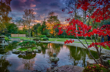 LONDON, circa 2016 - Sunset shot showing exquisite details of lush Japanese gardens including a fountain during early autumnのeditorial素材