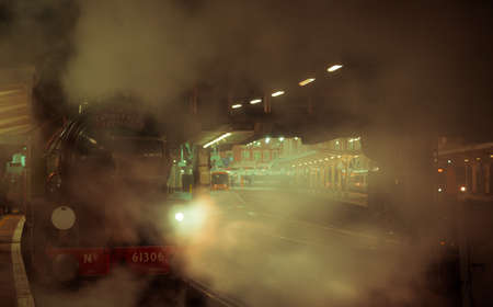 LONDON, circa 2016 - A steam train pulling off the station at night in London, UKのeditorial素材