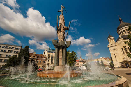 CLUJ-NAPOCA, circa 2015 - An ultra wide-angle shot featuring the Dormition of the Theotokos Cathedral and water fountain in Cluj Napoca, Romaniaのeditorial素材