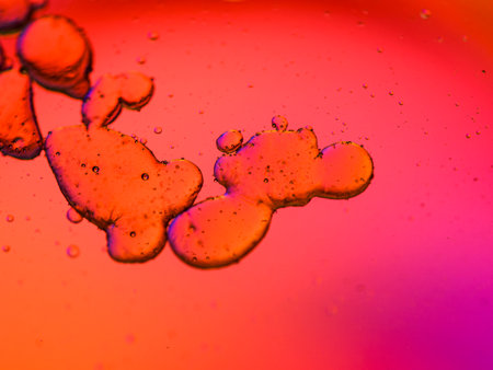 oil drops in water with colored background, macro photo of oil drops