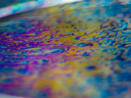 abstract background macro shot of oil drops on water surface with rainbow colors