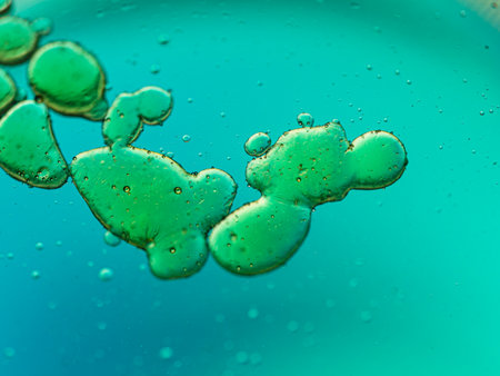 abstract green bubbles in water on a blue background close-up