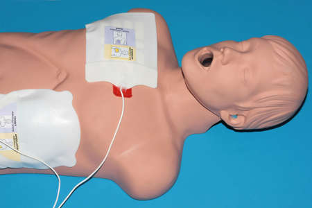A dummy recieving CPR on a blue background.の写真素材