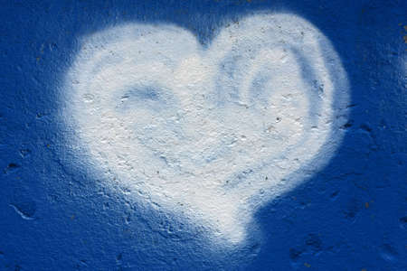 A grafity of a heart on a blue wall. の写真素材