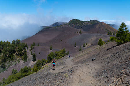 Man and woman running on volcanic path, Ruta de los Volcanes, La Palma, Spainの写真素材