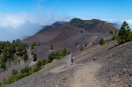 Man and woman running on volcanic path, Ruta de los Volcanes, La Palma, Spainの写真素材