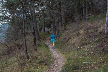 Female running in mountains at Lake Gardy, Lombardy, Italyの写真素材