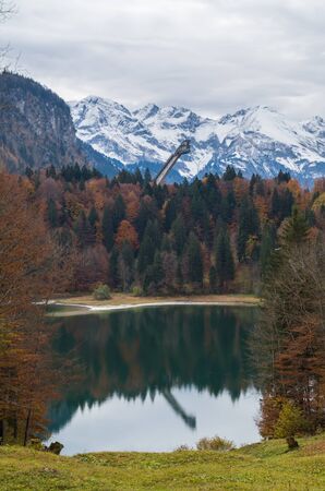 Lake Freibergsee with autumn forest in the German alps near Oberstdorf, Germanyの写真素材