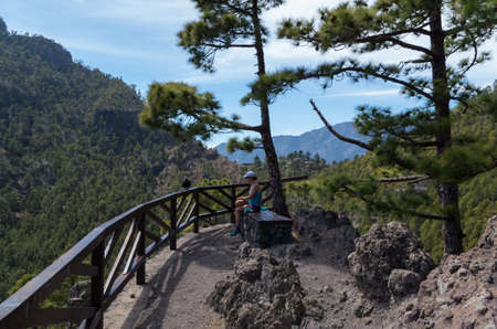Woman hiking and resting in beautiful lava landscape on the Cumbre Nueva in La Palma, Canary islands, Spainの写真素材